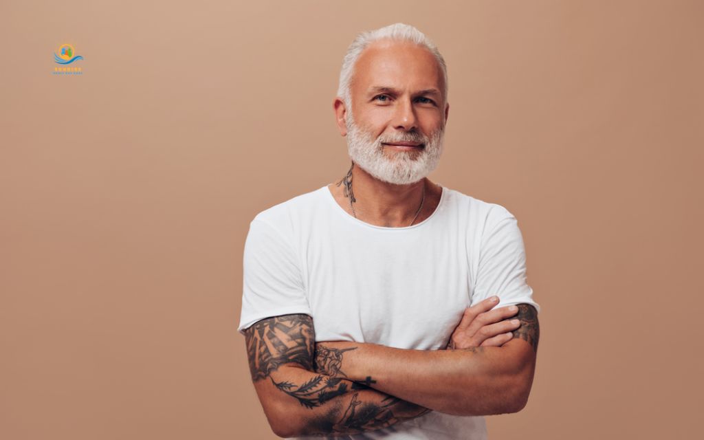 elderly person with tattoos: "Ink does not ask permission to grow old."